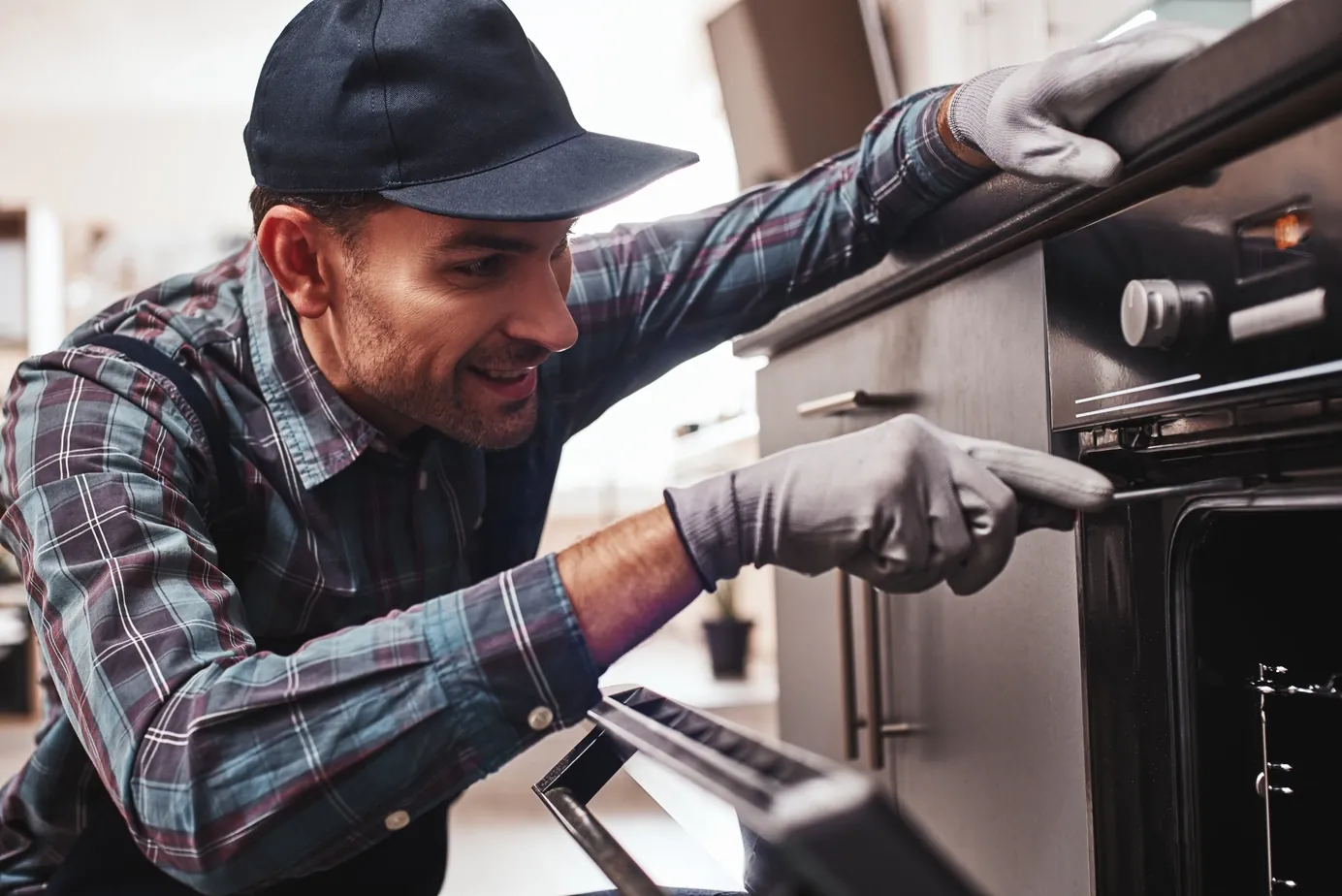 Engineer repairing an oven in a Bristol home